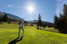 Golf player on a sunny day in Verbier